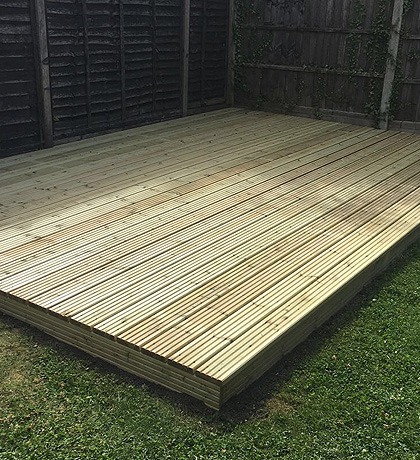 A square of new timber decking on a lawn