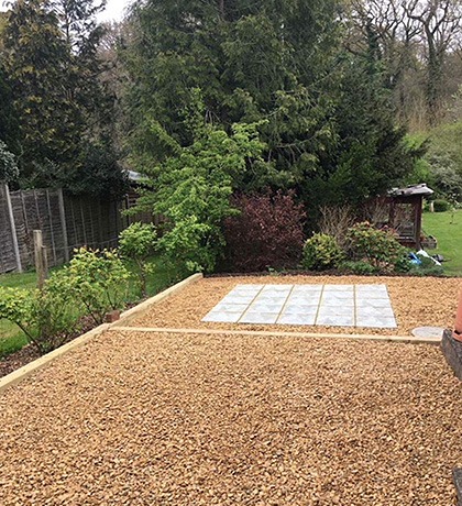 A gravelled garden area with a slab base laid in the middle