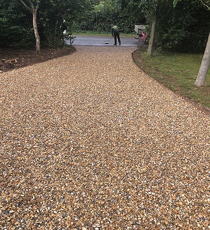 Close view of the new gravel drive curving between grass verges