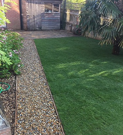 New turf beside a gravel path and timber edging