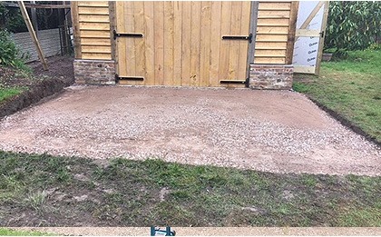 A level base laid in front of a timber shed
