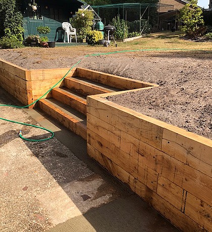 A sleeper retaining wall with sleeper steps built into it